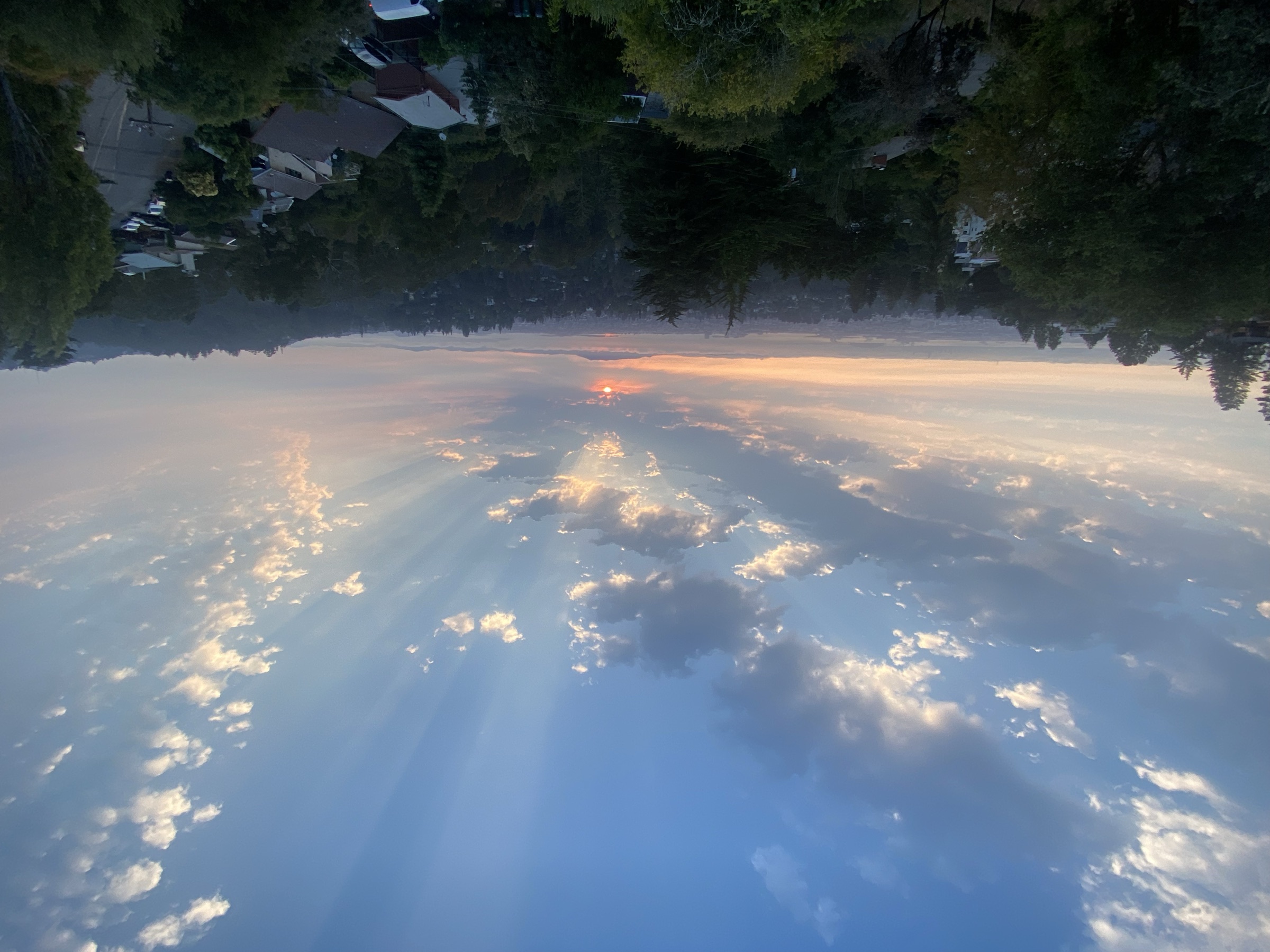 Crepuscular rays spreading across a summer sky at sunset