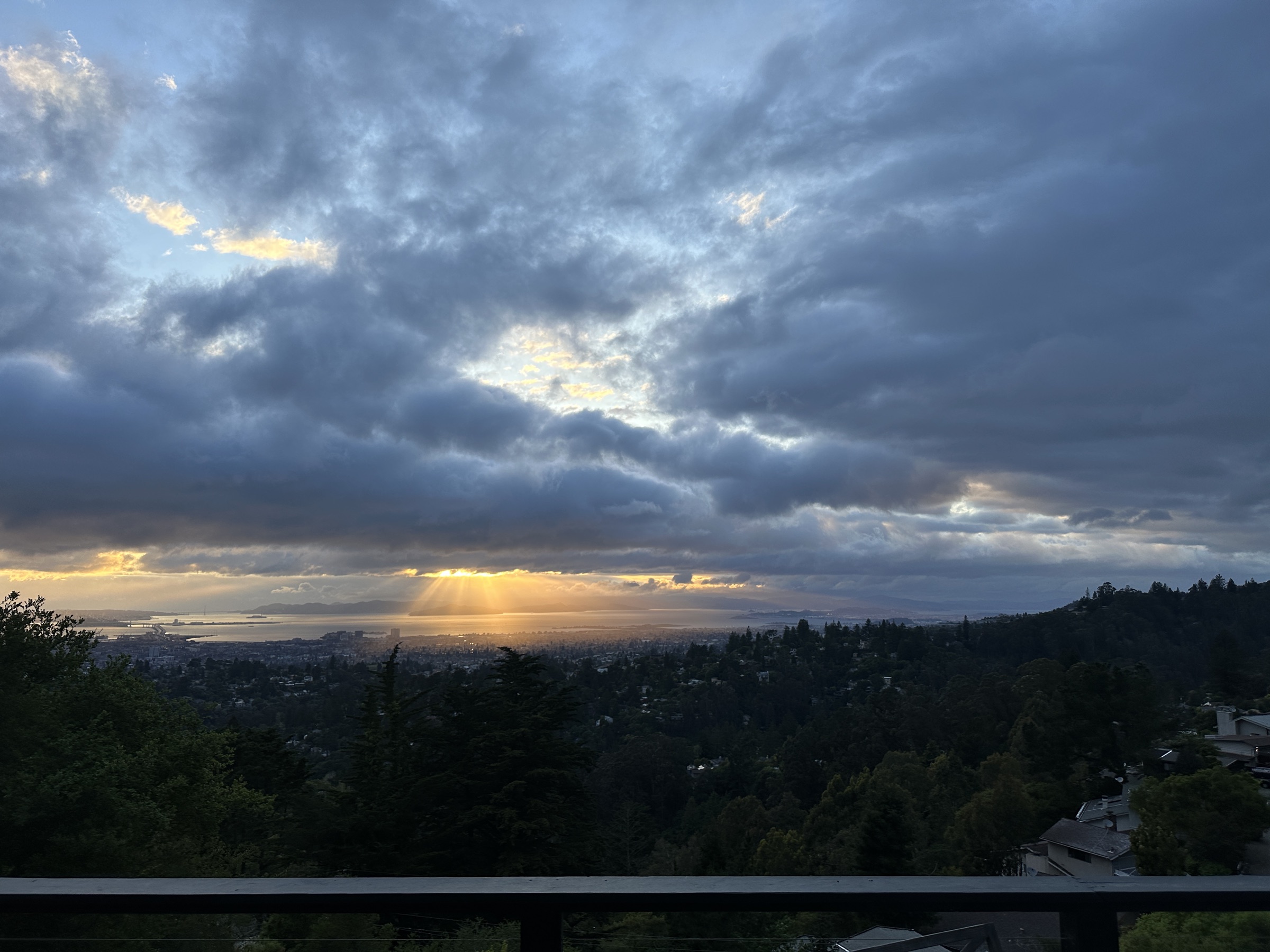 Sunbeams breaking through storm clouds above the Bay