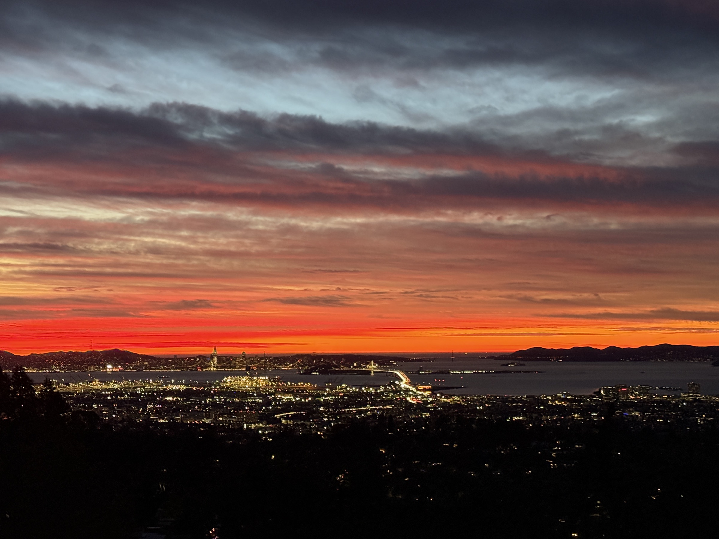 A vivid red winter sky over Oakland and the Bay